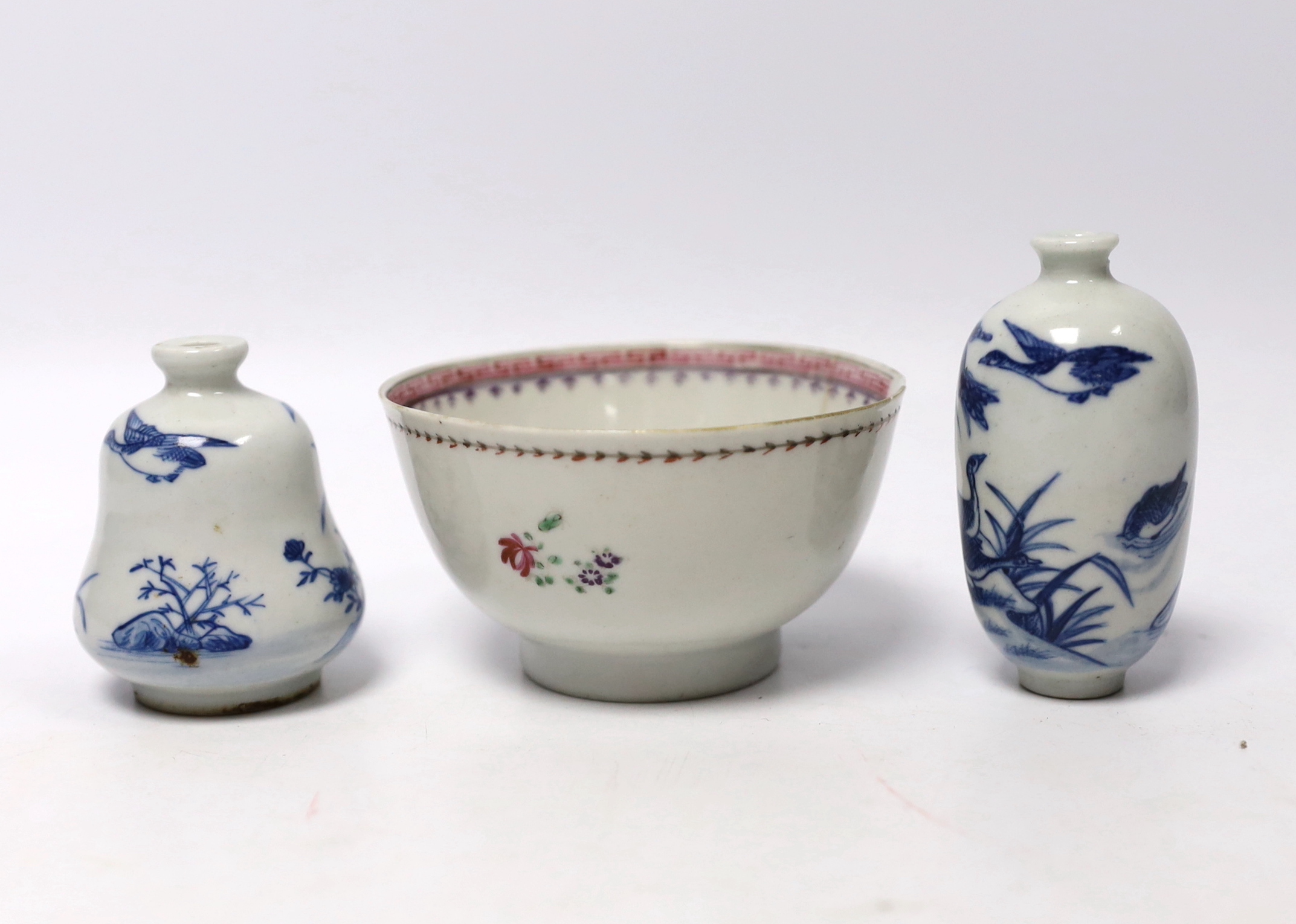 Two Chinese blue and white snuff bottles and a famille rose tea bowl, highest 7cm